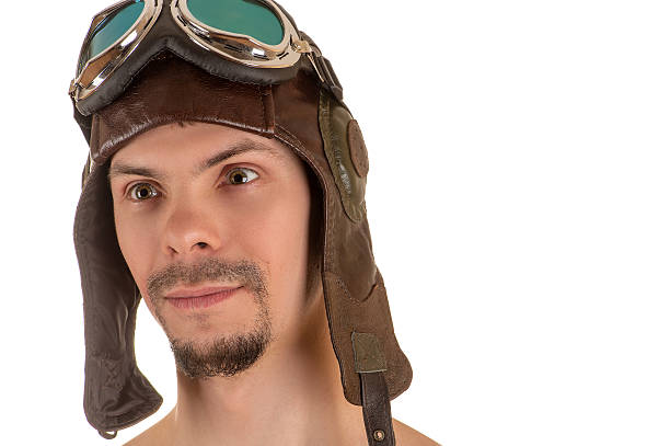 istock smiling man with mad look in flight helmet and goggles 531302988