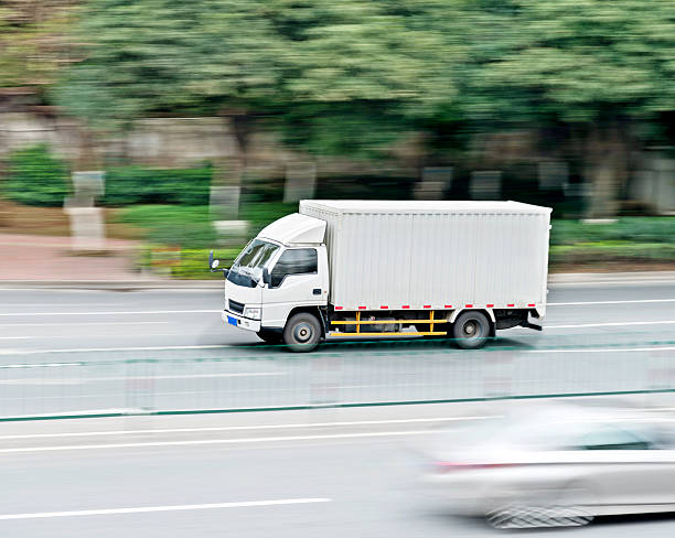 istock White freight truck driving on the road 531303182