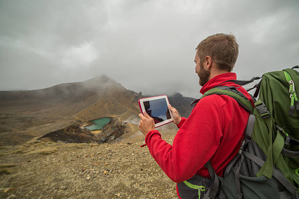 istock One young man hiking uses a digital map-New Zealand 531304092