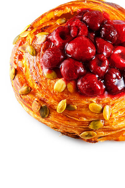 istock Bun with raspberry and pumpkin seeds on a white background 531304492