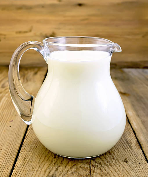 istock Milk in glass jug on board 531304499