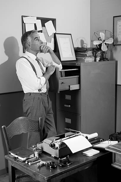 istock Pensive office worker looking for a file in the cabinet 531304636