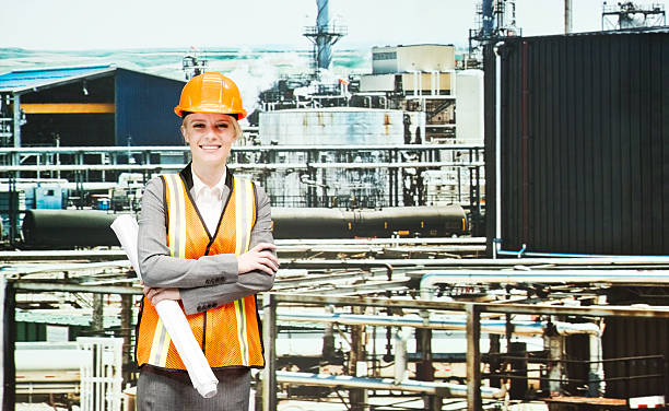 istock Cheerful female engineer with blueprint 531305045