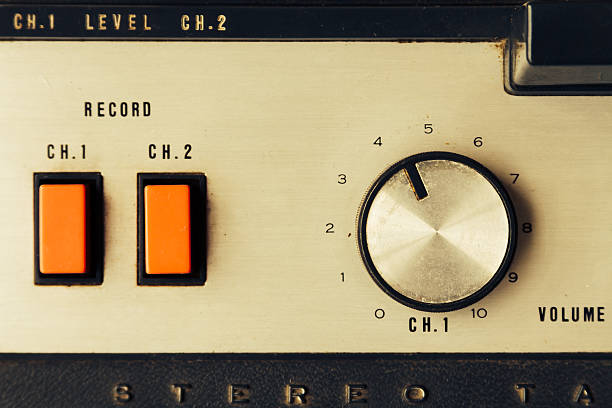 Overhead view of knobs and buttons of open tape recorder