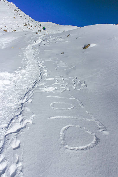 istock Team of mountaineers going toward summit with snow and wind 531306098