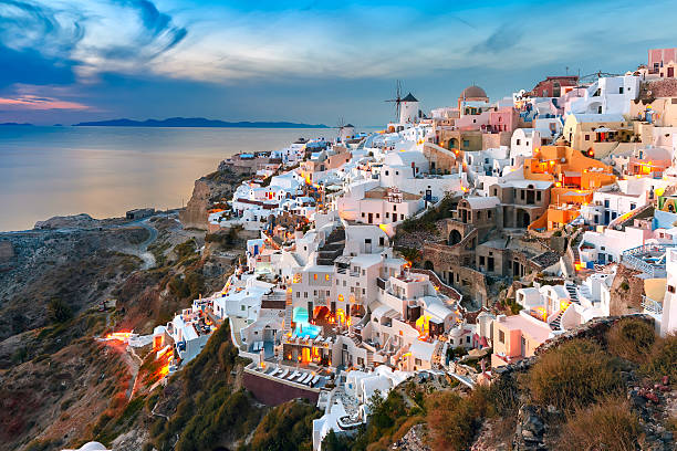 Oia at sunset, Santorini, Greece Picturesque famous view, Old Town of Oia or Ia on the island Santorini, white houses and windmills at sunset, Greece santorin stock pictures, royalty-free photos & images