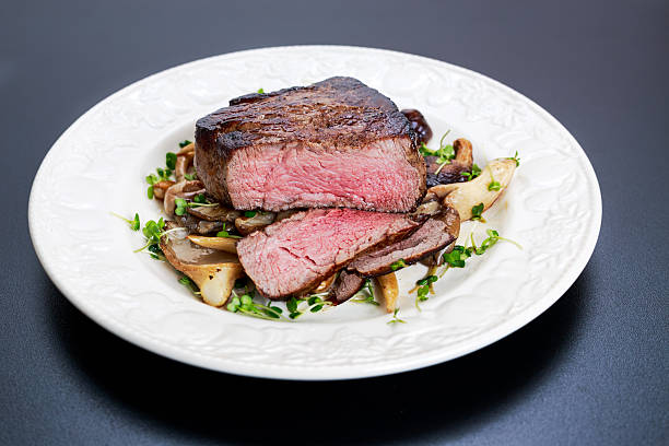 istock Tasty Beef Mignon steak with mushrooms and herbs on plate. 531308728