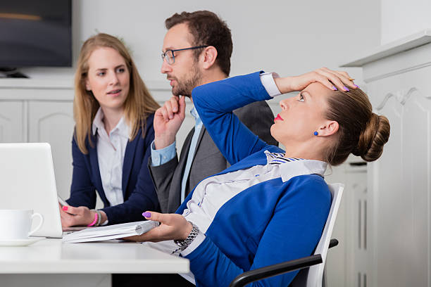 Dissatisfied businesswoman on a meeting Young female professional doesn’t agree with the opinion of her colleagues on a business meeting ignoring photos stock pictures, royalty-free photos & images