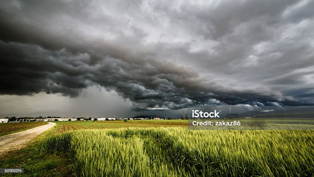 storm over the fields a storm is growin up over the fields of italy Storm Stock Photo