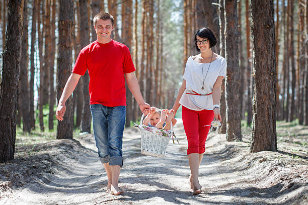 Happy family walking in the forest stock photo