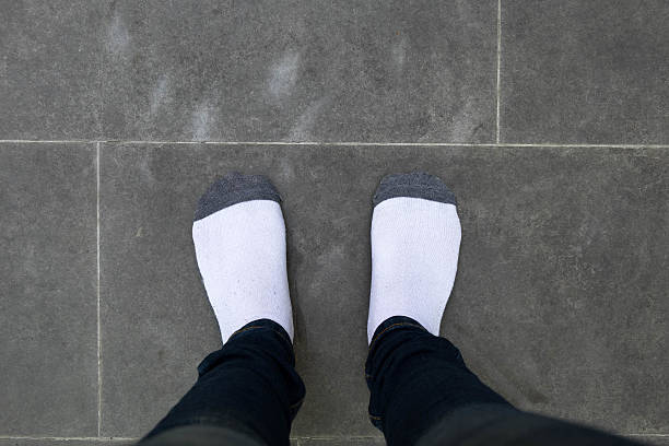 istock girl with black pants and sock standing on cement floor 531312488