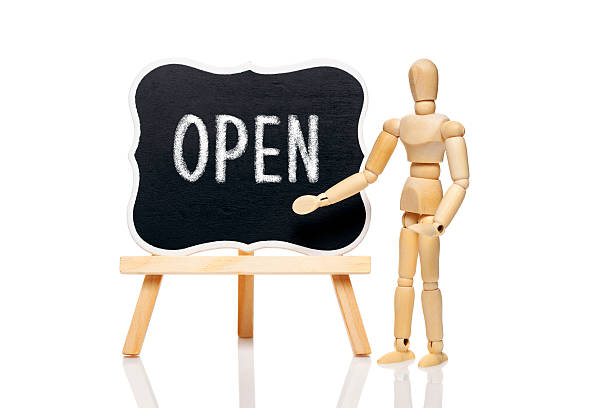 Open Wooden puppet and text ,, Open" written on blackboard , isolated on white background man writing on white board stock pictures, royalty-free photos & images