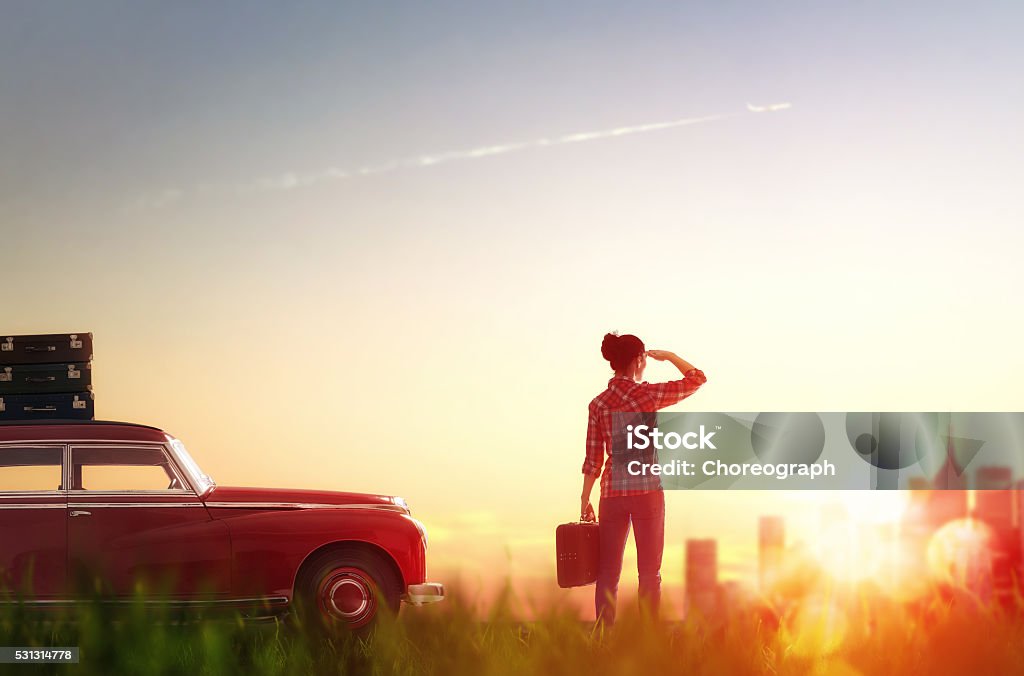 Go on an adventure! Toward adventure! Girl relaxing and enjoying road trip. Beautiful young woman looking on city. Adult Stock Photo