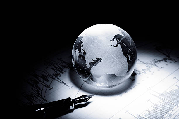 istock business concept of a glass globe on a trading chart 531315050