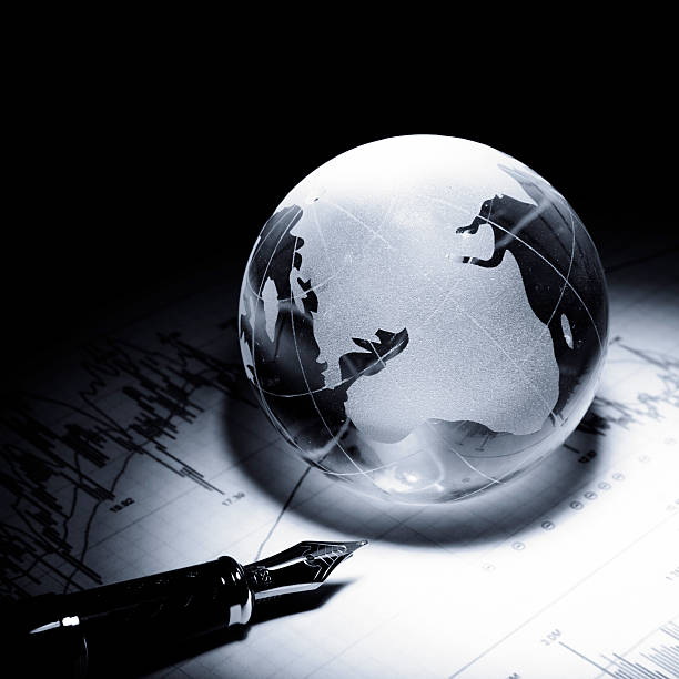 istock business concept of a glass globe on a trading chart 531315192