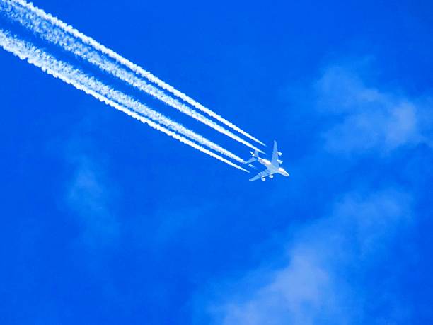 istock Airplane with chemtrails on blue sky 531317110