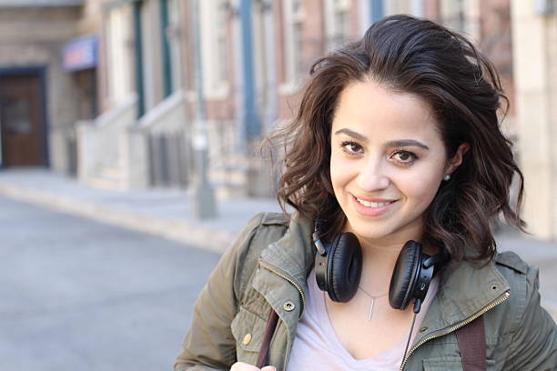 istock Young woman wearing a green jacket posing 531318008
