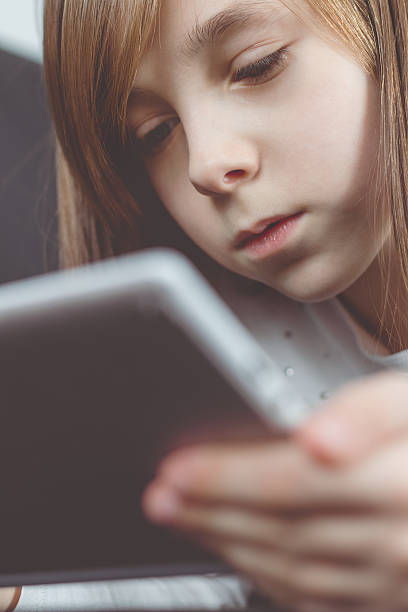 istock Girl reading messages on tablet 531318086