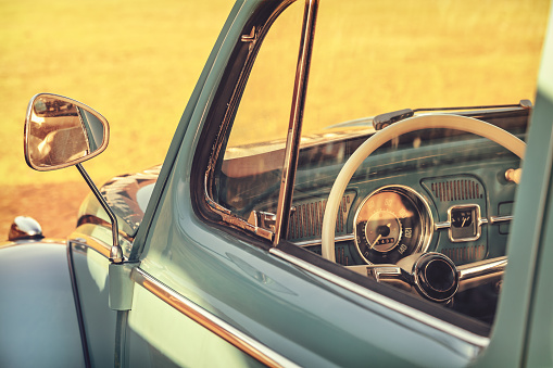 Retro styled detail of a classic car on a summer day during sunset