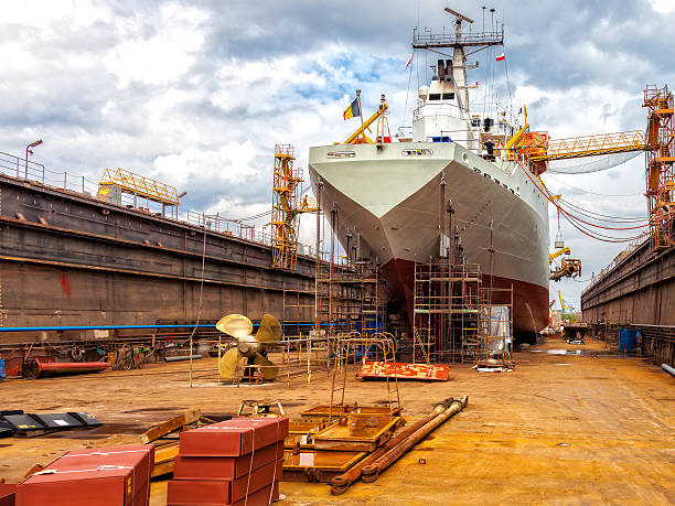 Ship in dry dock Big ship - rear view with propeller under repair. gdansk photos stock pictures, royalty-free photos & images