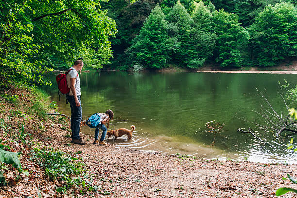 istock Father and daughter by lake 531318906