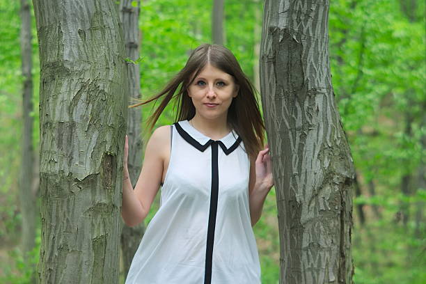 Beautiful young girl in middle of forest.