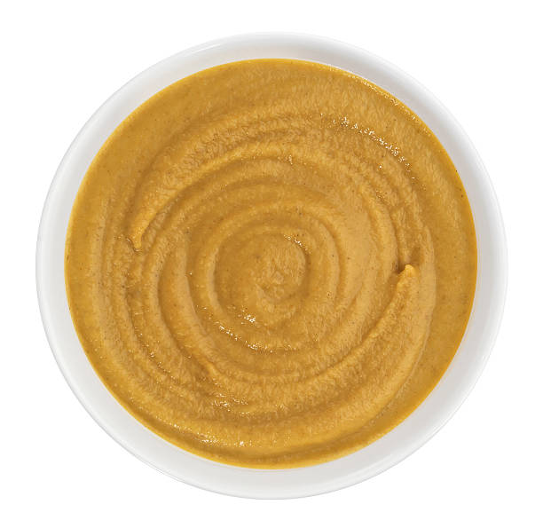 istock Mustard in bowl isolated on white background. Top view 531319878