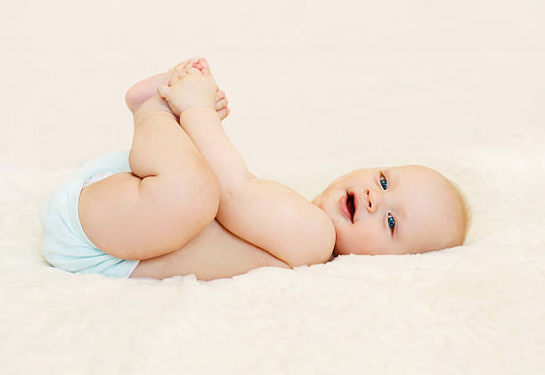 istock Happy smiling baby lying playing on the bed at home 531320618