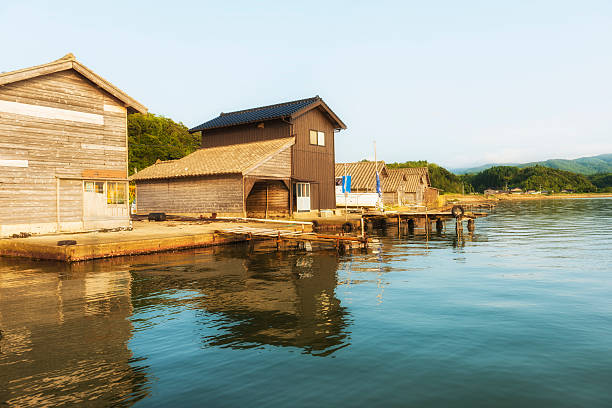 Ryotsu atLake Kamo Wooden seasonal hauses of fishermens that cultivating shellfishes on Lake Kamo on Sado Island in Sea of Japan. It is summer day. Sado stock pictures, royalty-free photos & images