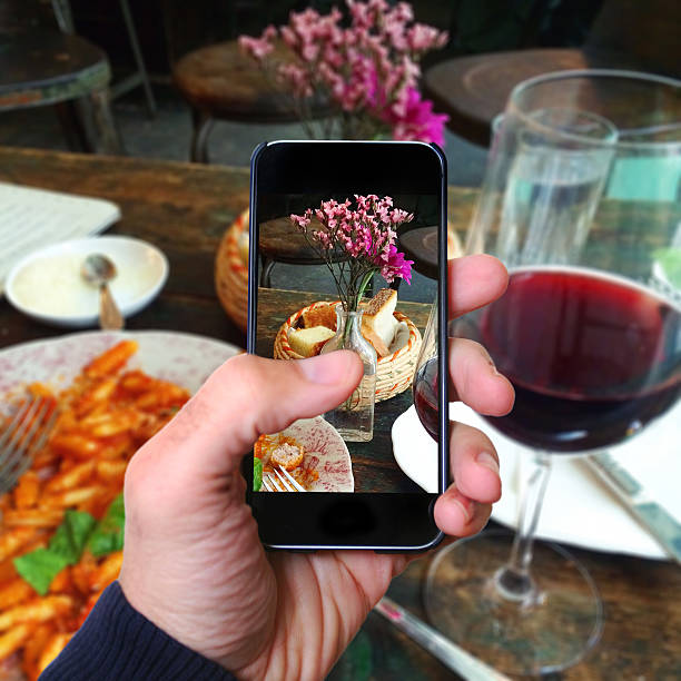 istock man taking phone snapshot of lunch 531321283