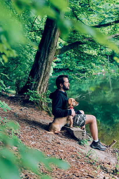 istock Man with the dog by the lake 531323526