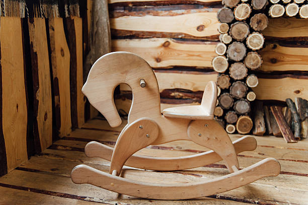 Old rocking horse on a rustic country backdrop.