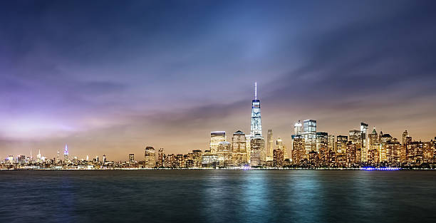 New York City Cityscape Panorama New York City Panorama. View of Manhattan Skyline under dramatic cloudscape. Long Time Exposure. Manhattan, New York City, USA. lower manhattan stock pictures, royalty-free photos & images