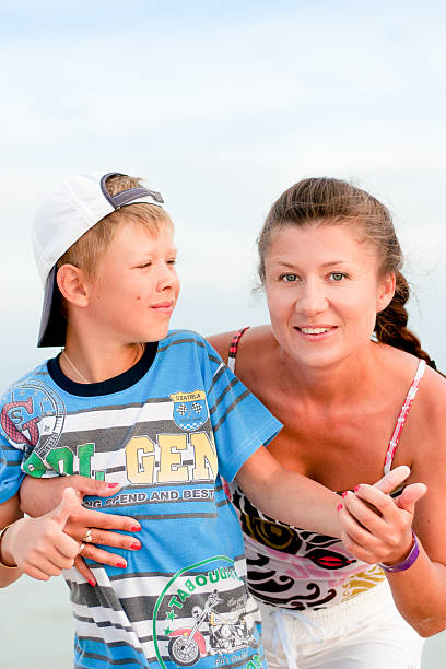 istock the boy with his mother on the beach 531325026