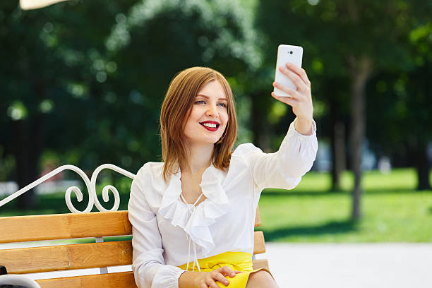 istock Young Woman Shooting Selfie in the Park 531325328