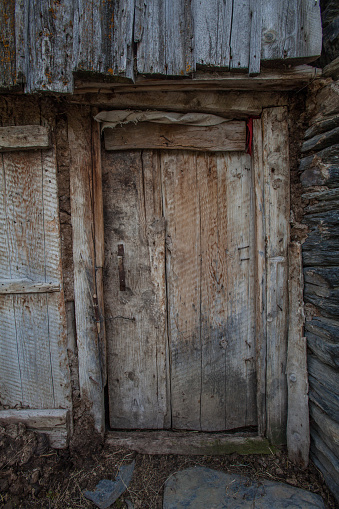 An old rustic door of an ancient stone house in a Svaneti mountain village in Republic of Georgia