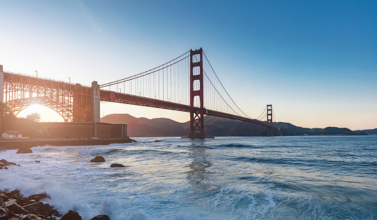 Panorama of famous Golden Gate Bridge in beautiful sunset light. Golden Gate Bridge, San Francisco, California, USA.