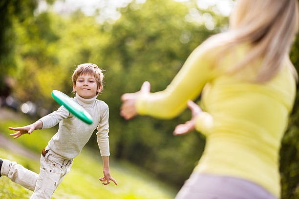 istock Mather and son playing frisbee in the park. 531327261