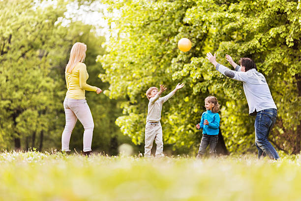 istock Family playing with ball in nature. 531327275