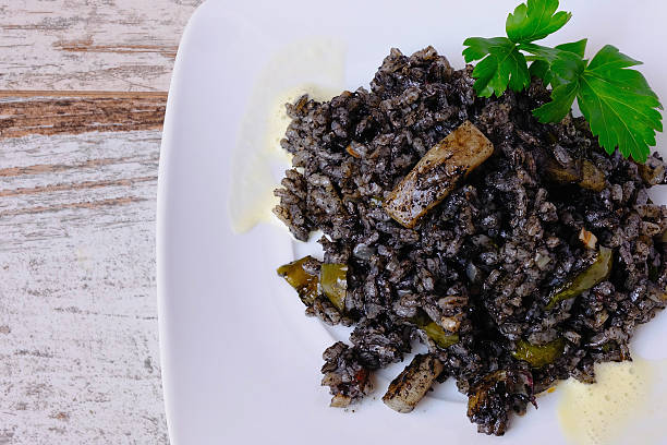 Arroz negro spanish recipe, black paella with cuttlefish. 