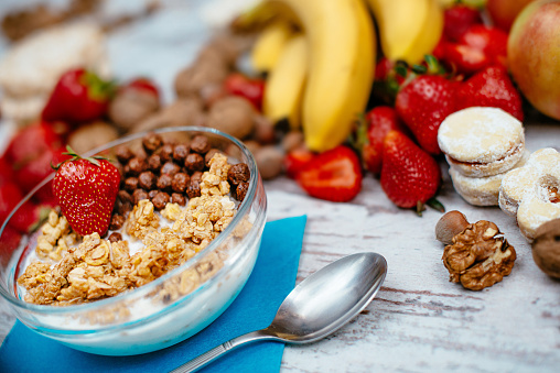 Fresh organic strawberries, bananas, nuts, cinnamon and bowl of mixed cereals and corn-flakes. Image taken with Nikon D800 and 50mm or 85 m professional Nikon lens, developed from RAW and distributed in XXXL size. Location: Europe