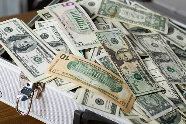 istock Case with pile of dollars. 531330144
