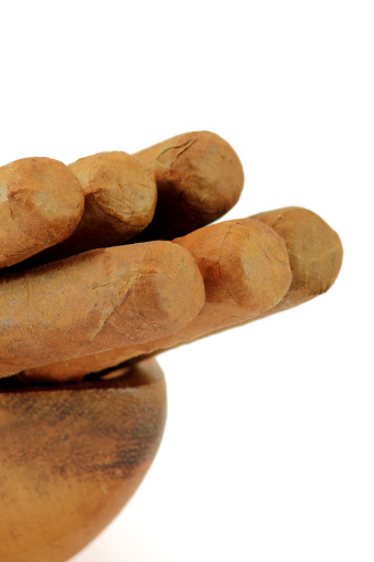 Closeup of cigars rolled with loose tobacco leaves. Cuban cigar habanos.