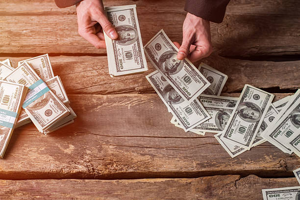 istock Male hands counting dollars. 531330702