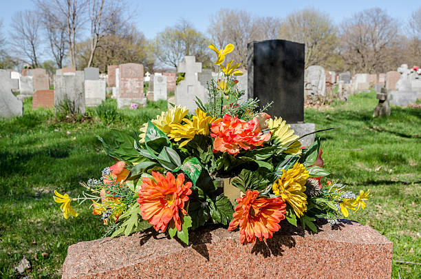 istock Flowers on a tombstone in a cemetary 531331596