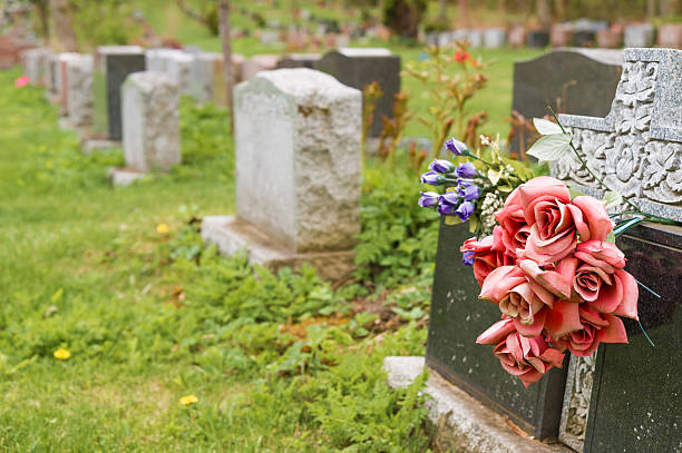 istock Flowers on a tombstone in a cemetary 531331738