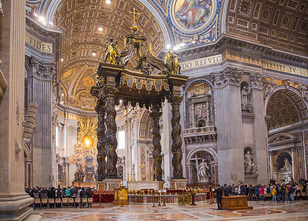 Interior of the Basilica of St. Peter in the Vatican Rome, Italy - April 9, 2016:  Interior of the Papal Basilica of St. Peter in the Vatican with lots of tourists  peter the apostle stock pictures, royalty-free photos & images