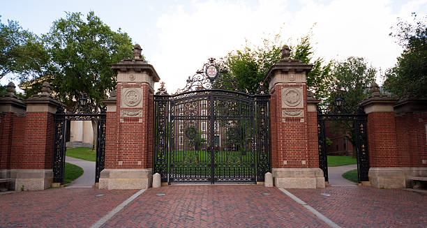 Gate at entrance to Brown University in Providence, Rhode Island Providence, United States - August 9, 2014: A closed gate is seen outside the entrance to the Front Green on the campus of Brown University along Prospect Street. Brown University, a private Ivy League university that was founded in 1764, is the 7th oldest institution of higher learning in the United States and currently has over 8,000 enrolled students. brown university stock pictures, royalty-free photos & images