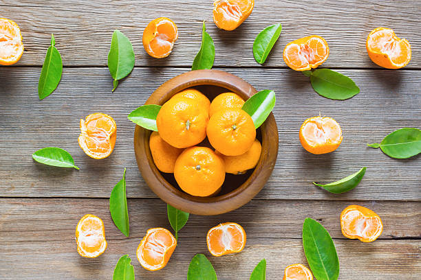 istock fresh mandarins on old wooden table background 531334176