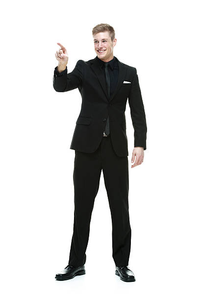 istock Smiling businessman pointing away 531345843